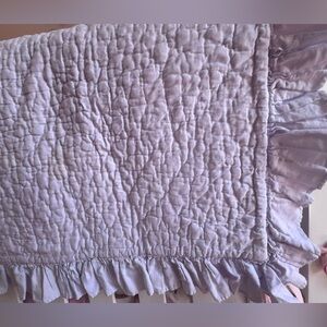 Pottery Barn ruffle quilt for crib in lavender.